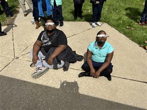 Two students looking at the eclipse